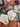 Embroidered fans and decorative items on a textured surface