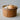 Terracotta cheese Faisselle with holes containing an onion and garlic on a neutral background