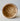 Vintage Faisselle cheese mold with holes on a light background