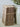 A set of three vintage brown  rag books tied together with twine, standing upright next to a large ceramic vase with dried greenery on a neutral surface.