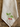 A cream-colored linen kitchen towel with embroidered green leaves and raspberry motif, laid flat on a rustic wooden surface.